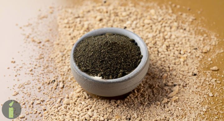 a bowl of powder in a pile of sand
